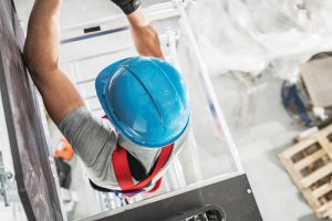 a worker climbing on scaffolding equipment