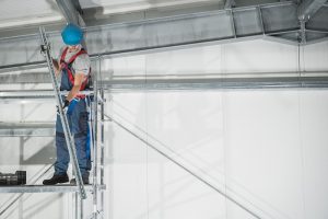 worker on scaffolding in a warehouse