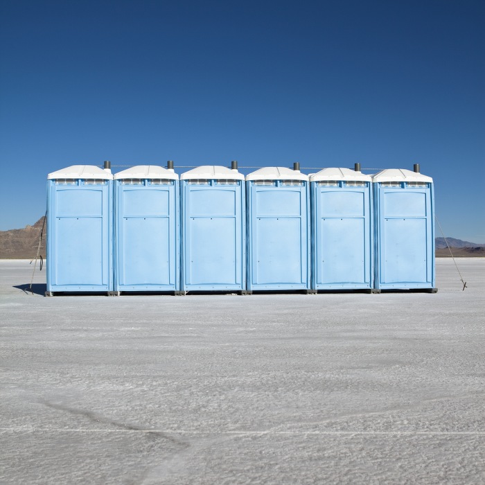 blue portable toilets on salt flats